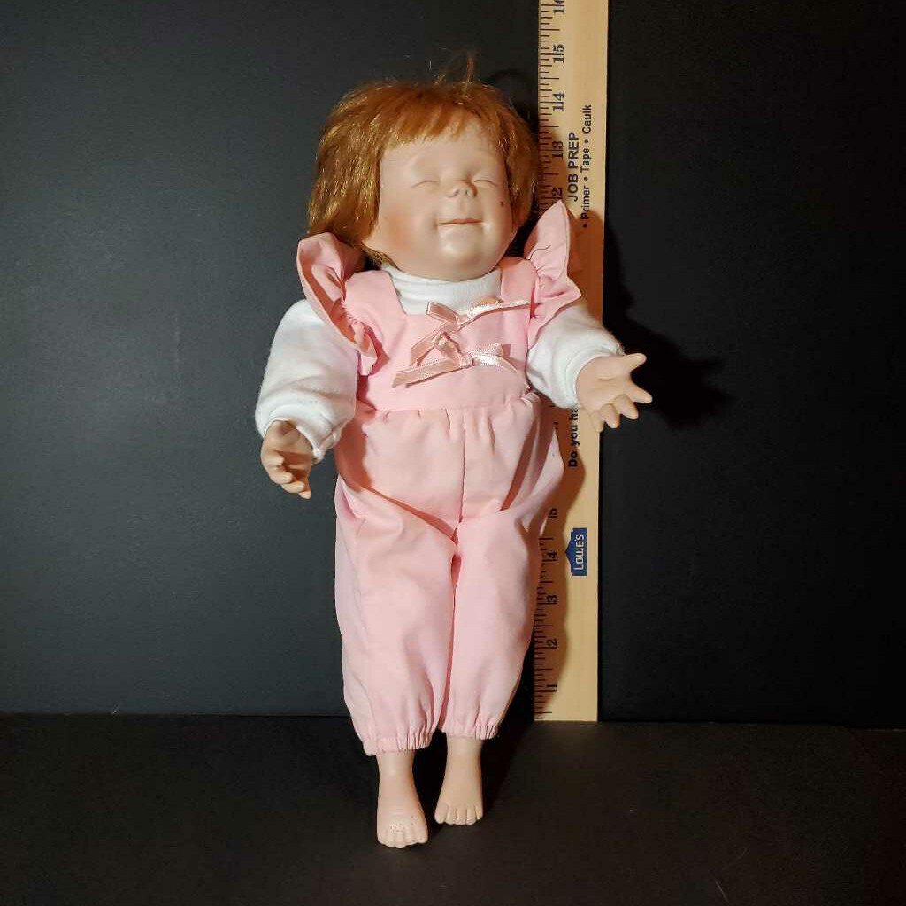porcelain doll in pink outfit